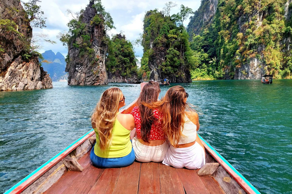 Enjoy a scenic long-tail boat cruise across the emerald-green waters of the lake.