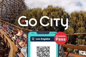 Go City all-inclusive-pas, der vises på en smartphone med en forlystelsespark-rutsjebane i baggrunden