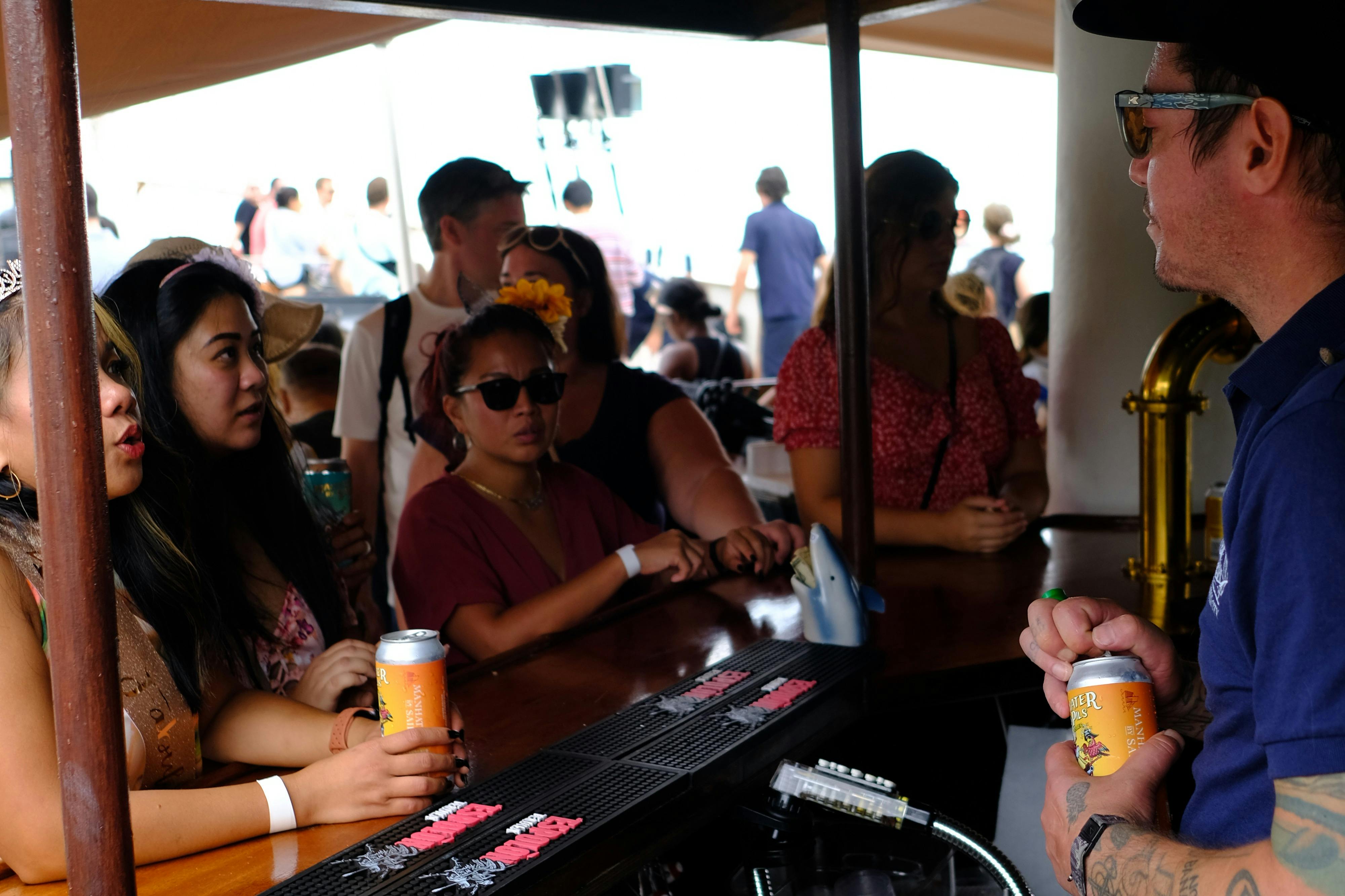 Guests ordering refreshments at the onboard full standing bar.