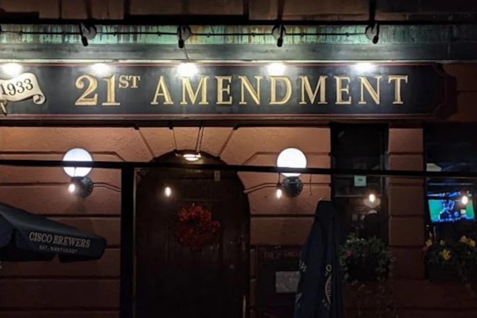 Nighttime entrance photo of the 21st Amendment