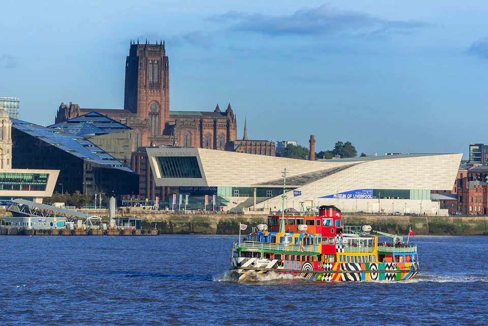 The Dazzle ferry on the River Mersey with the Anglican Cathedral in the background