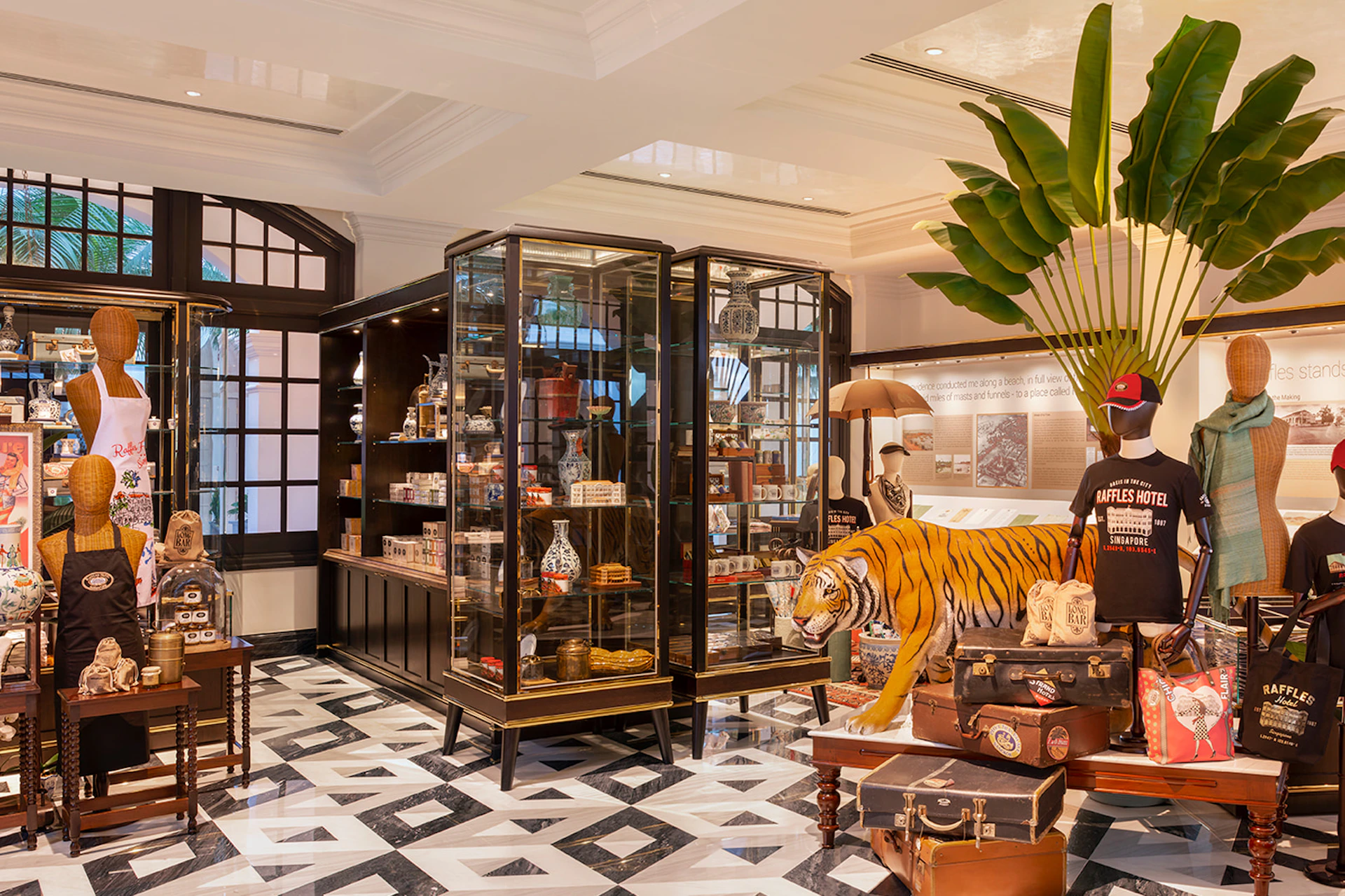 A sophisticated retail space with a tiger statue, glass display cases, and vintage-style decor. The floor has a geometric pattern.