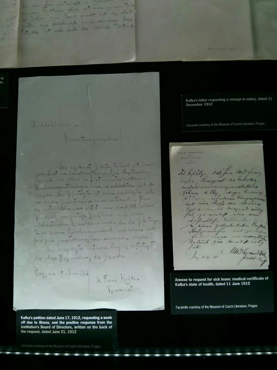 Handwritten documents displayed on a black background with explanatory text labels indicating the context from Franz Kafka.