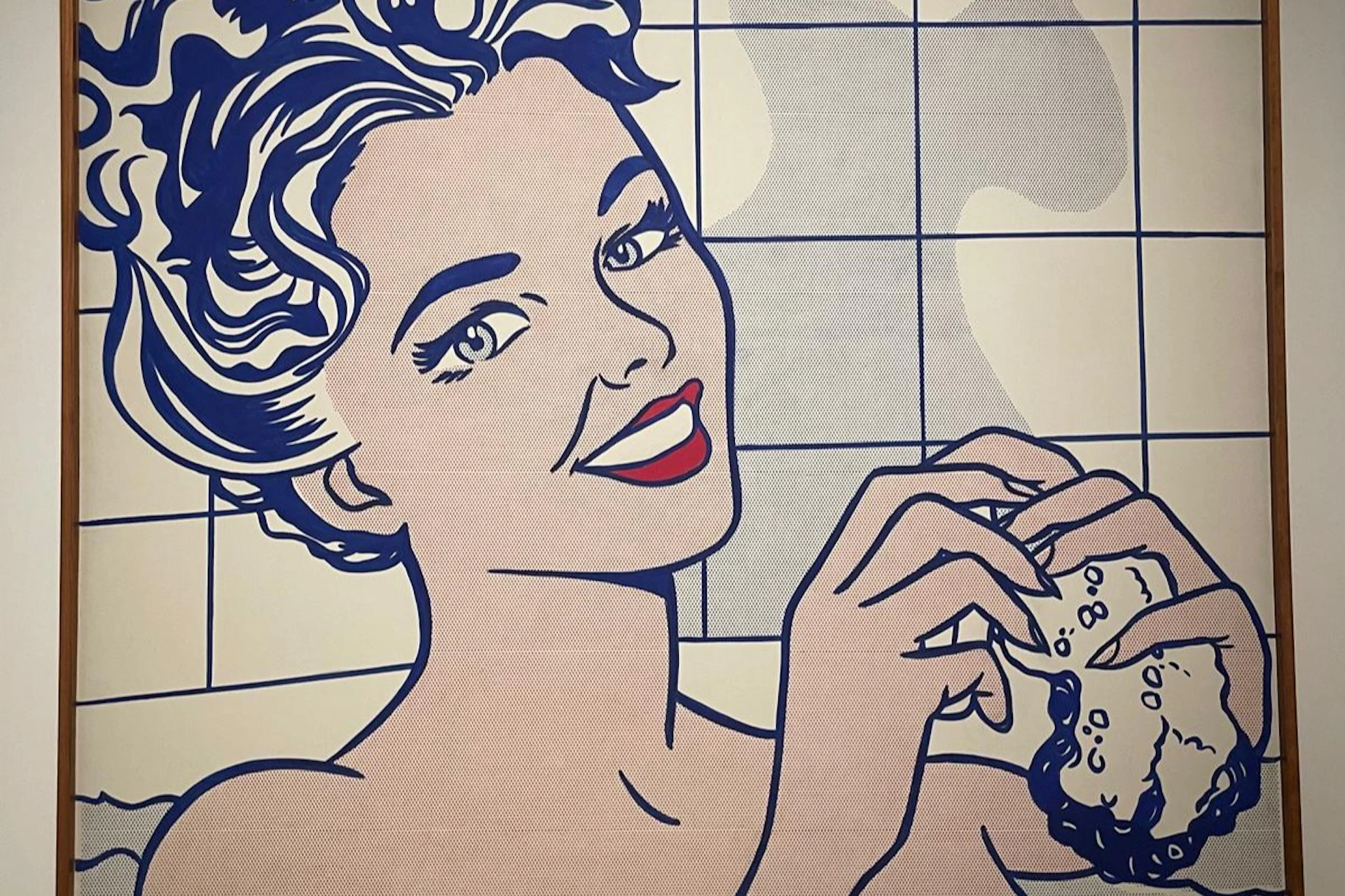 A pop art-style illustration of a smiling woman holding a sponge, with a tiled background.