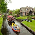 Cruising along the canals in Giethoorn on a small electric boat for a genuine local experience.