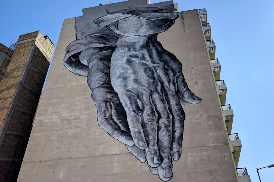 "Mural of praying hands"