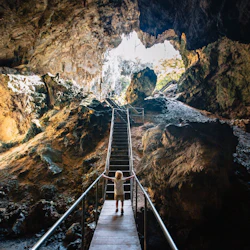 Emerge from the cave into a spectacular doline