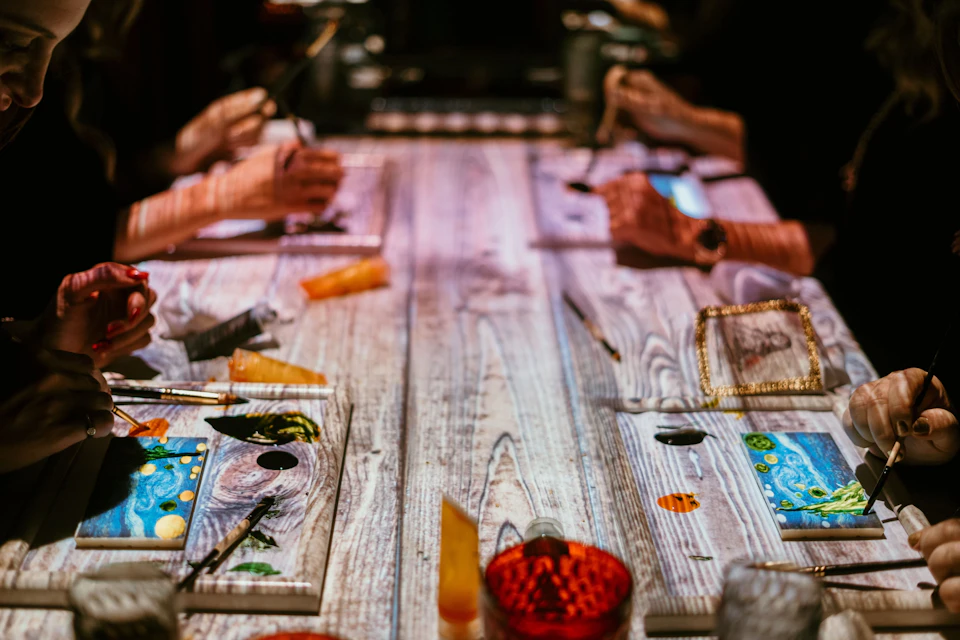 Guests are painting on a chocolate bar at the Seven Paintings immersive dining show.