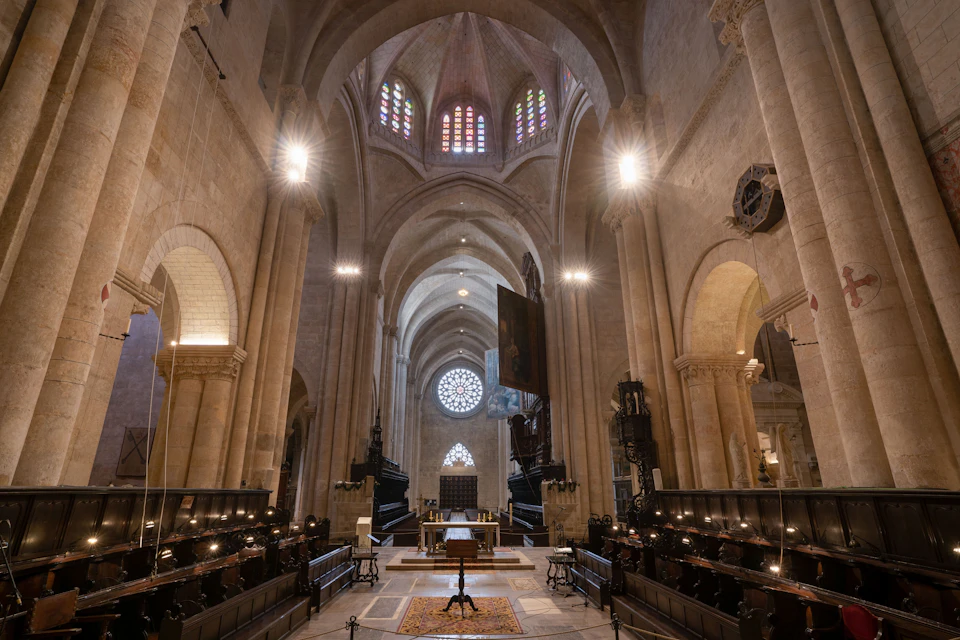Cathedral interior. Central and lateral nave, choir stalls and organ.