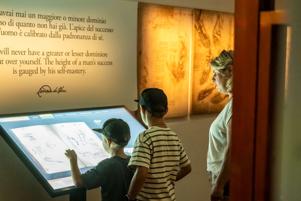 Family interacting with a touch screen inside the museum