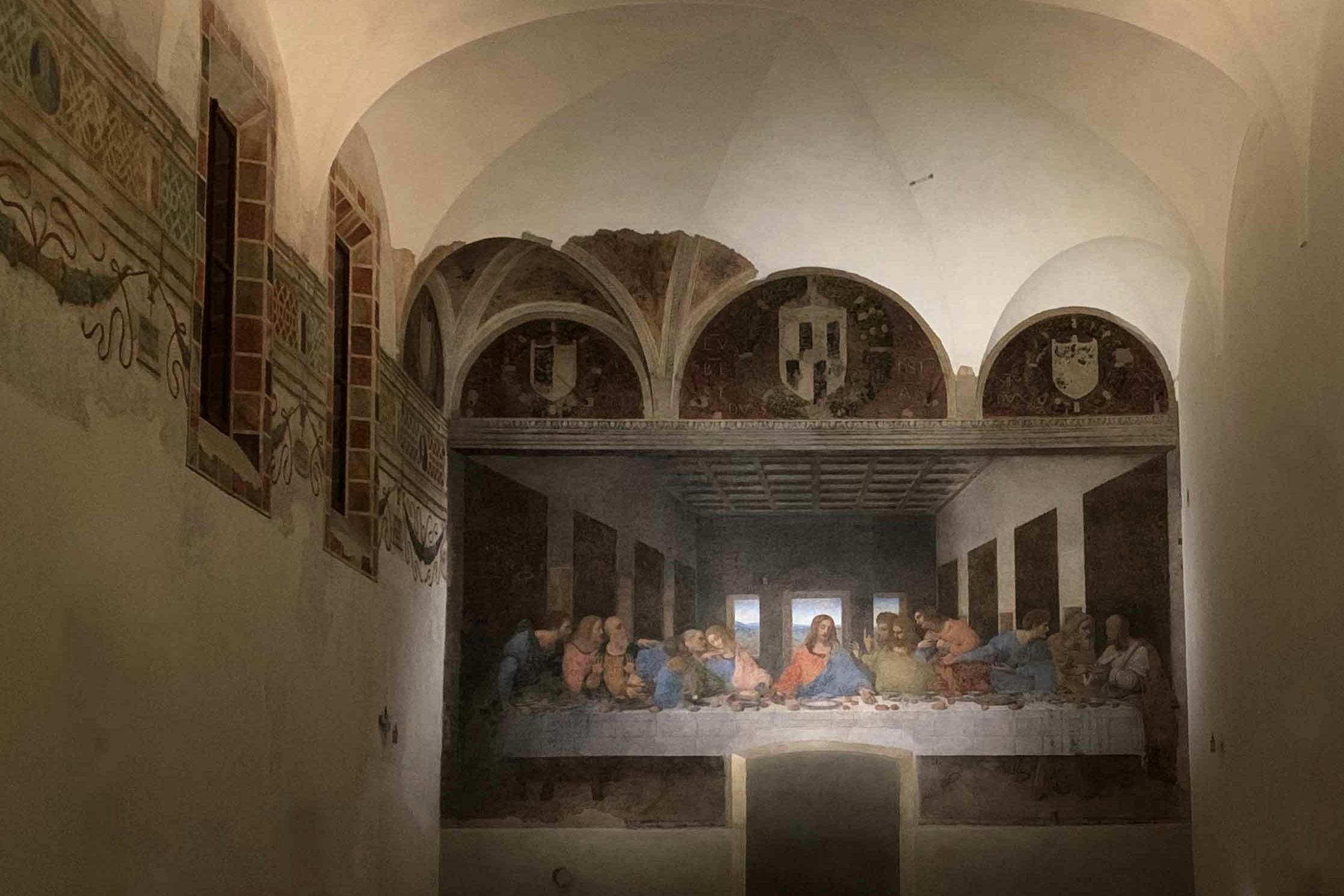 A depiction of Leonardo da Vinci's 'The Last Supper' fresco, shown in an arched room with decorative details.