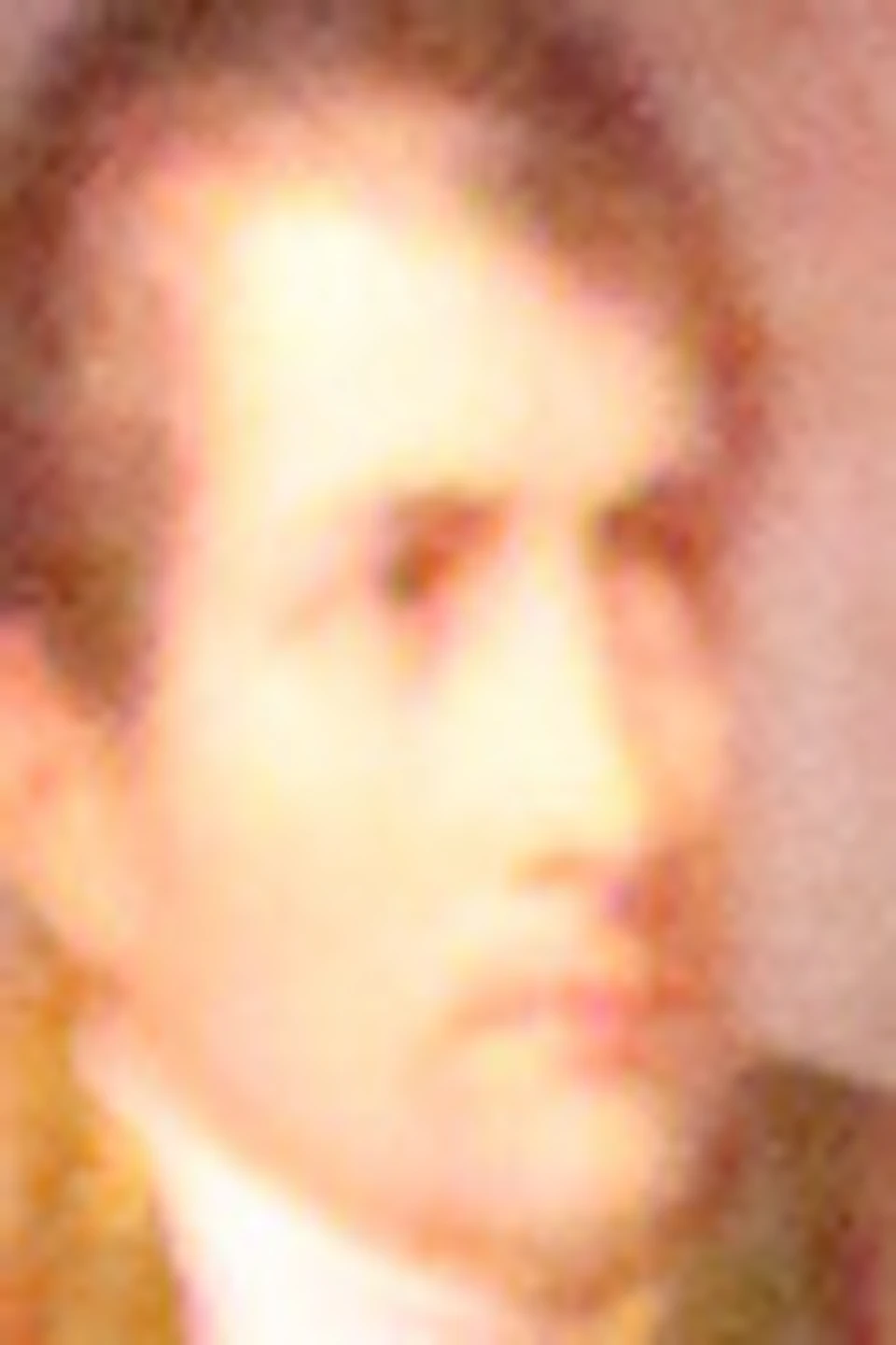 Ornate crib with draped canopy and eagle decoration in a dimly lit room. Portrait of a man in military uniform on the wall.