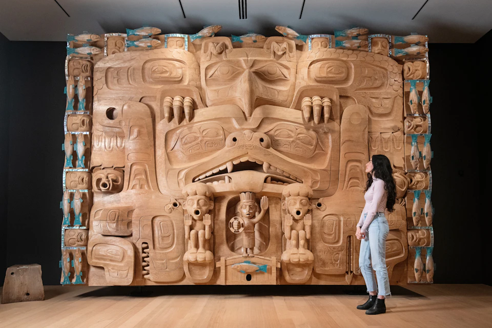 A front view of a red cedar dance screen carved by Haida artist, James Hart.
