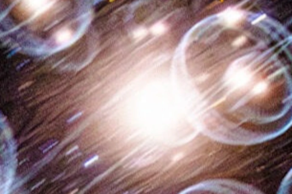 A planetarium show featuring a starry sky with bubble-like visuals projected on the dome above an audience.