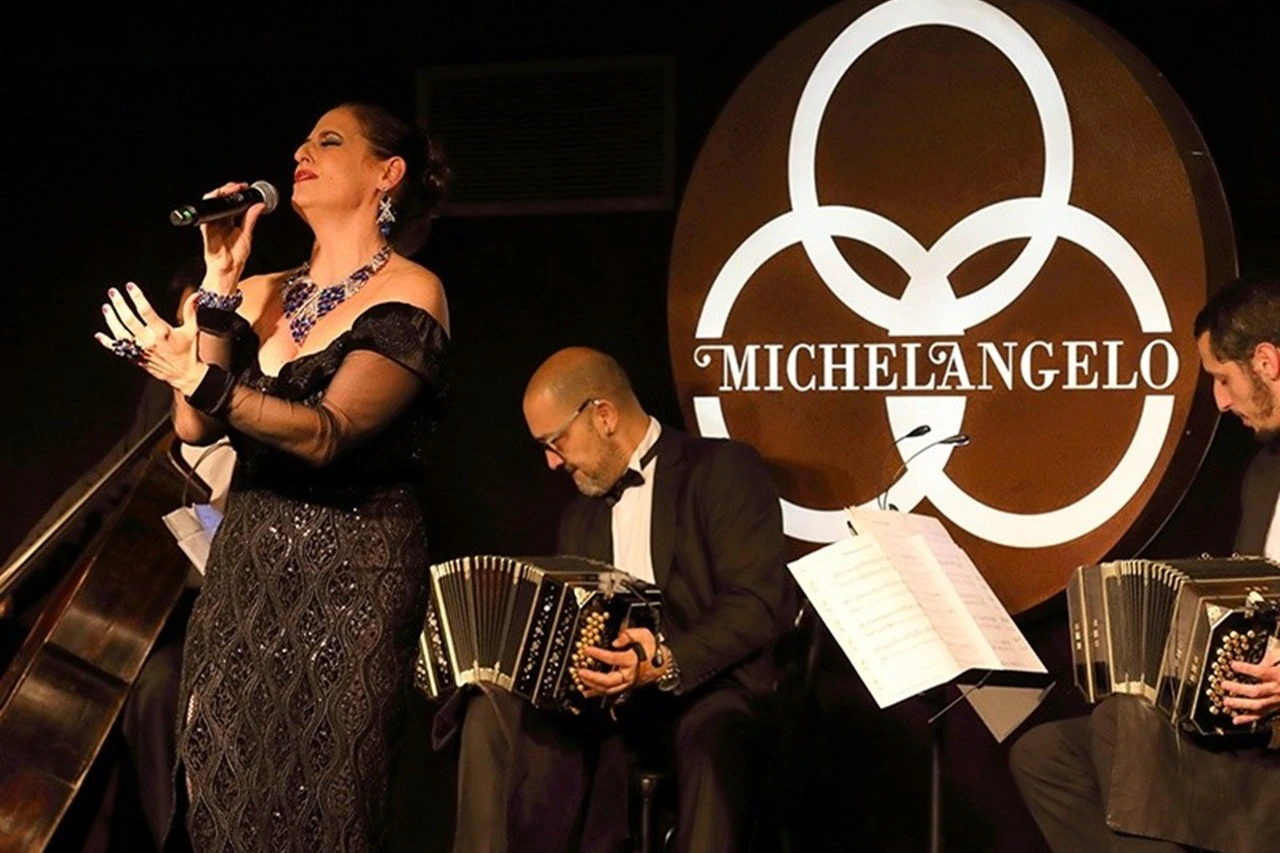 A captivating woman tango singer graces the stage, her voice weaving through the vibrant melodies of skilled musicians.