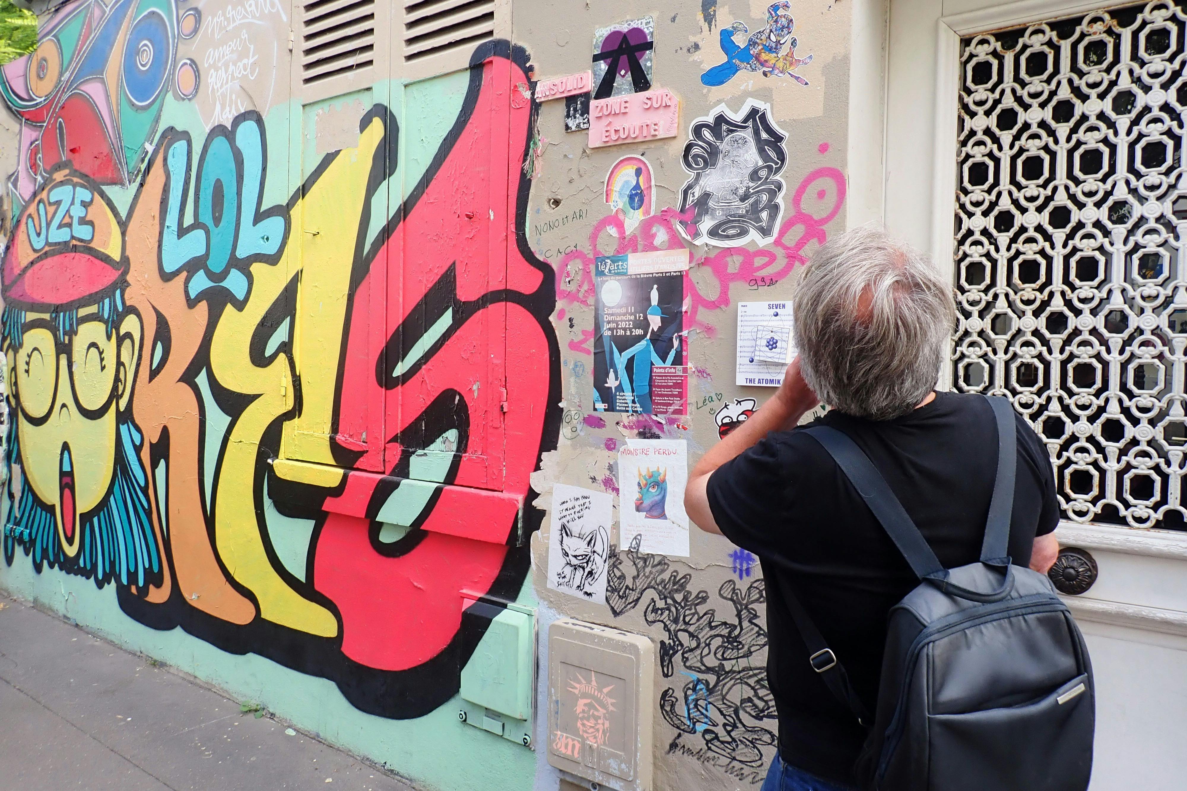 Guide in front of wall with street art