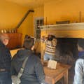 Docent leading a tour of the open-hearth kitchen.