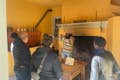 Docent leading a tour of the open-hearth kitchen.