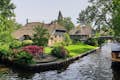 The best scenic spot in Giethoorn is the canals, thatched roof farmhouse, and arch-shaped wooden bridges.