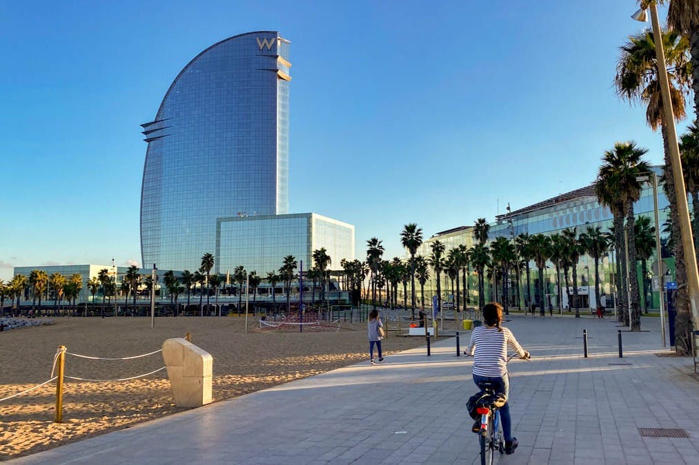 La Barceloneta with its beach, palm trees and the prestigious W Barcelona hotel.