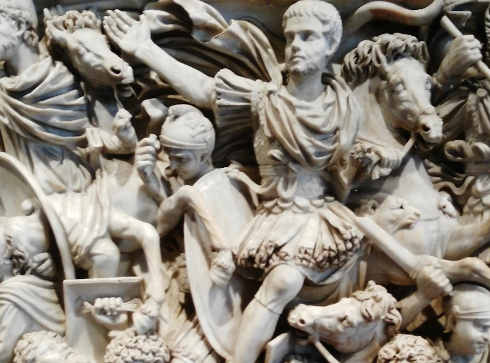 Intricate marble relief depicting a crowded, dynamic battle scene with soldiers and horses in various poses of combat.
