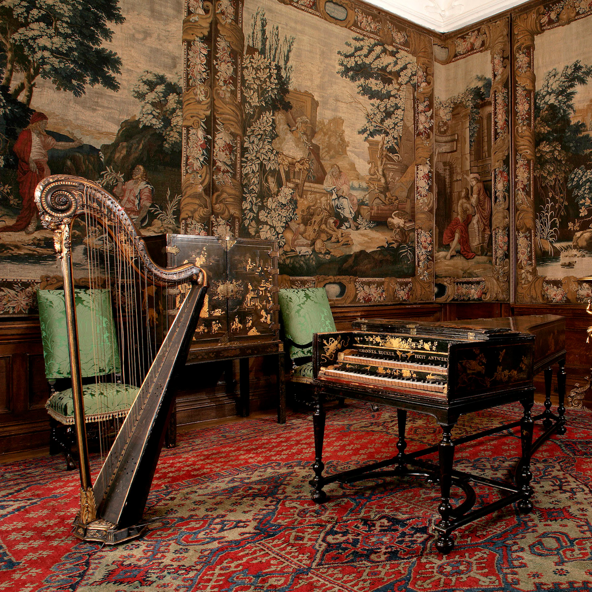 An ornate room with a harp and a decorated harpsichord. The walls are covered in detailed tapestries depicting pastoral scenes.