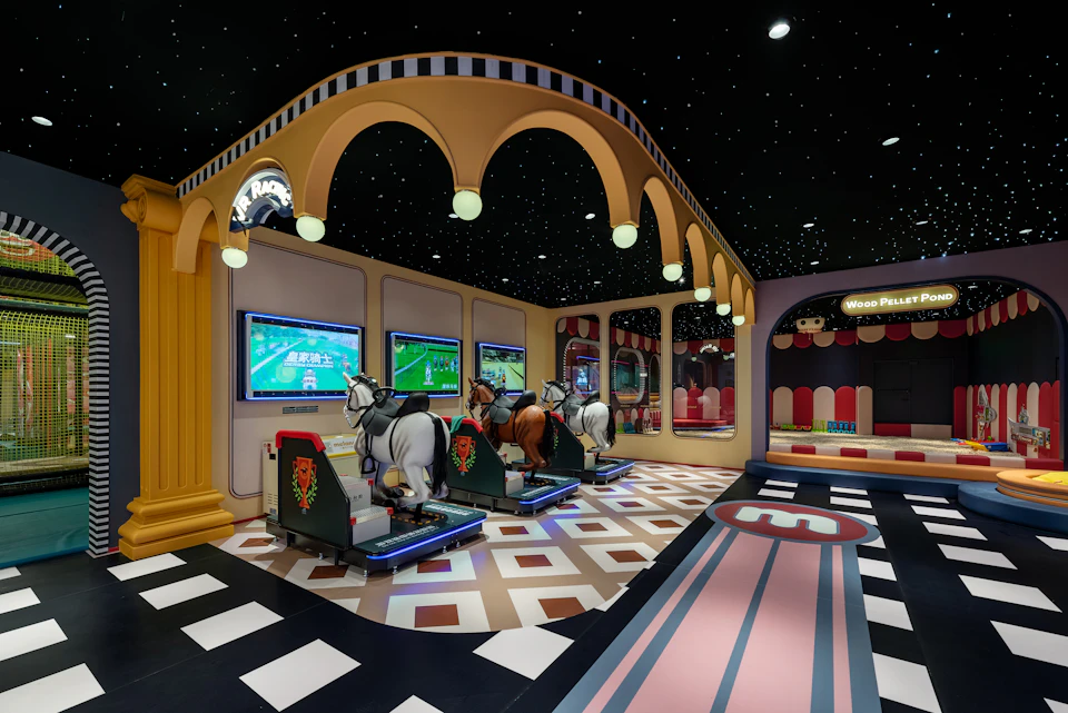 A themed entertainment area with arcade horse racing simulators under decorative arches and vibrant lighting.