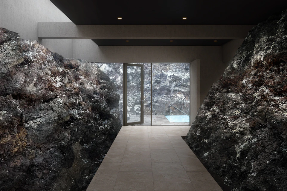 Interior hallway with rocky walls, a tiled floor, and a glass door leading to an outdoor area with a small pool.