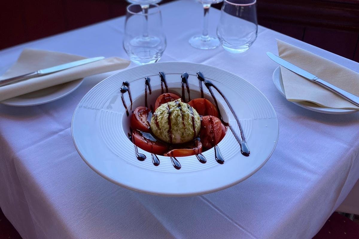 Tomatoes and burrata, balsamic reduction, pistou sauce