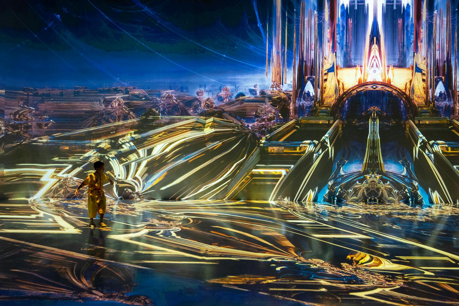 A person stands in a vibrant, futuristic environment with glowing structures and intricate, reflective designs.