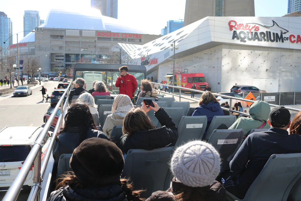 Open top double decker bus, approaching Ripley's Aquarium and Rogers Centre