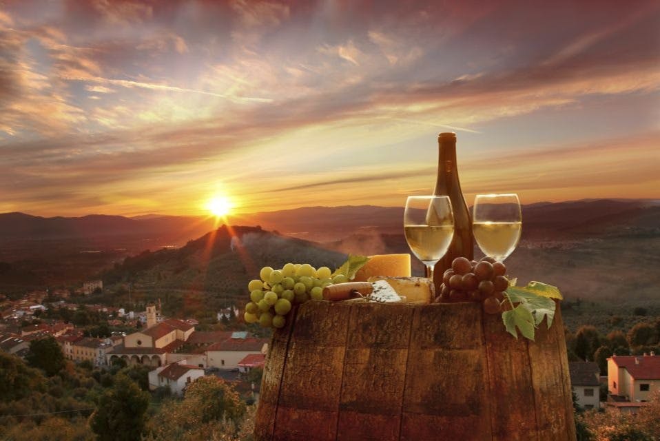 Glass of wine and typical Tuscan appetizer at sunset in Chianti.