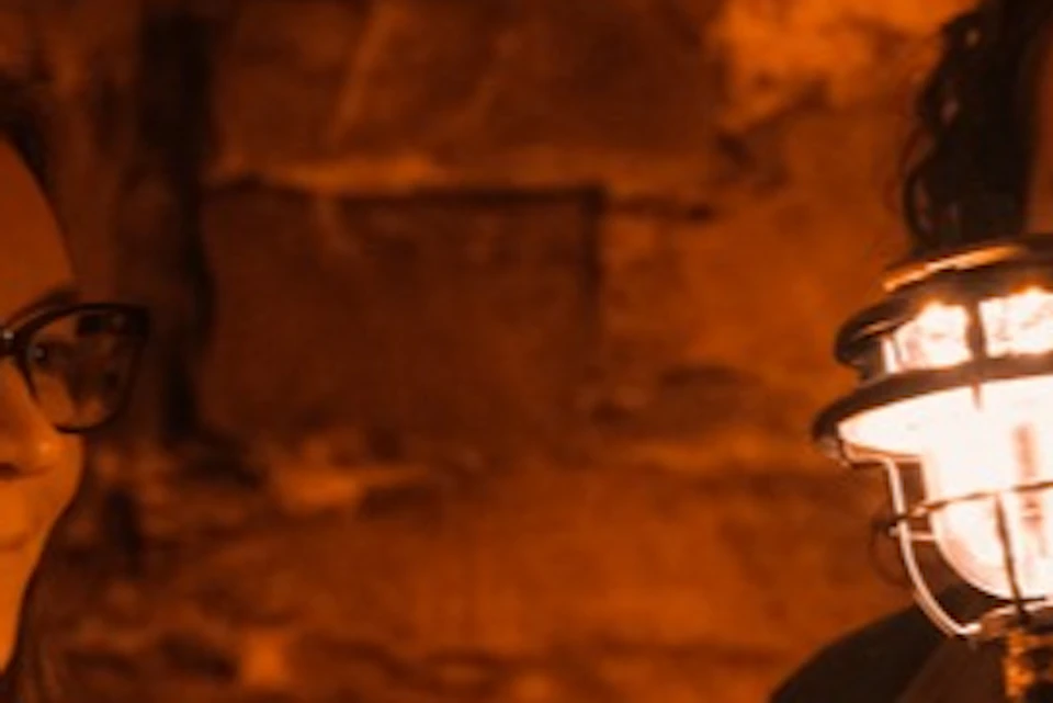 A storyteller tells stories to visitors in Blair Street Underground Vaults.