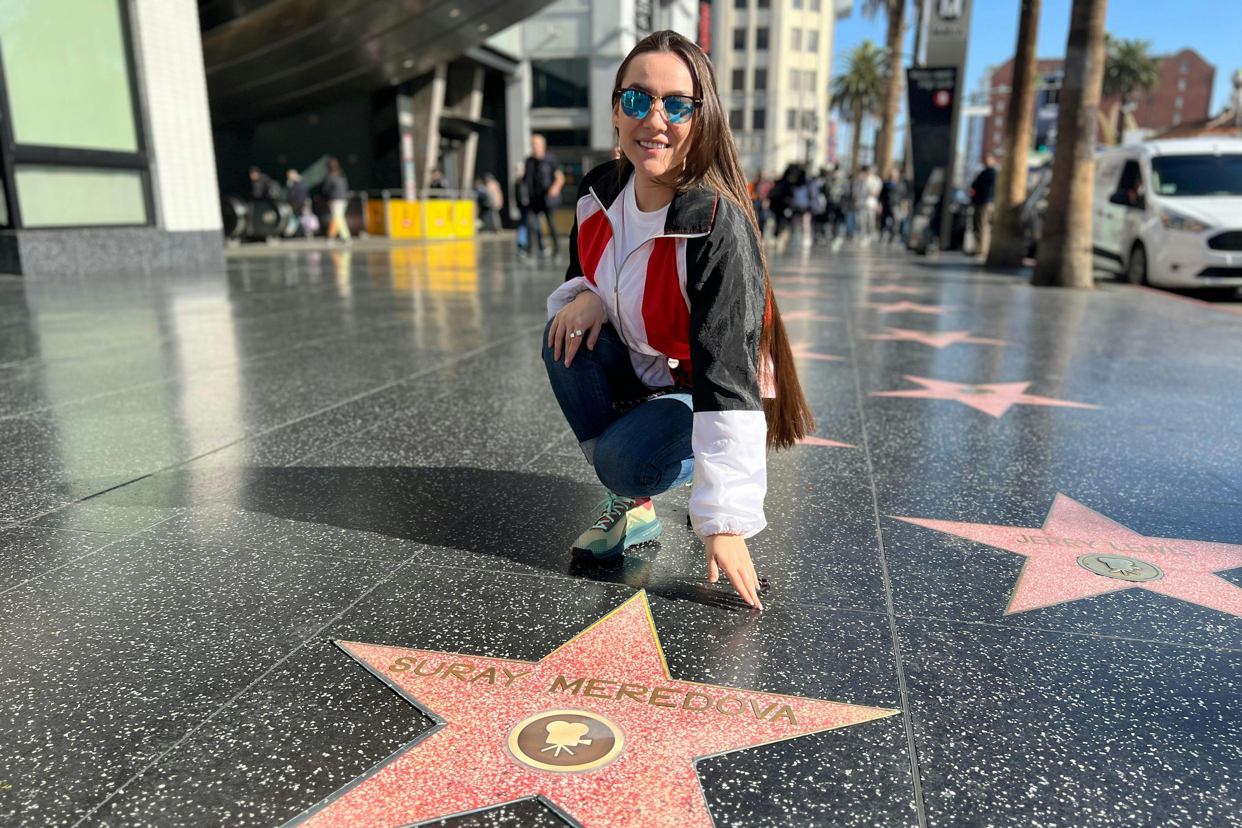 A  Hollywood Walk of Fame area  Tourist is happy with their own replica star personalized for a photo.#single