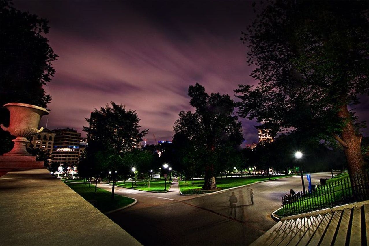 Nighttime photo of Boston Commons, with a spooky and mysterious sky.