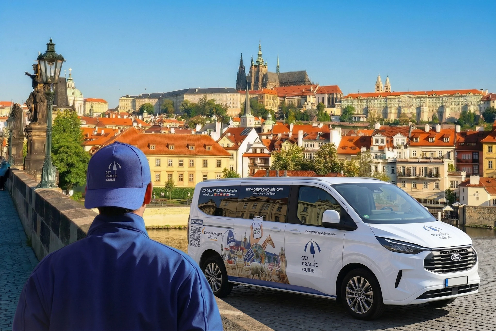 A person in a blue uniform stands near a van with 'Get Prague Guide' branding, with Prague Castle visible in the background.