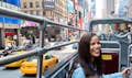 woman tourist at the top deck of big bus new york