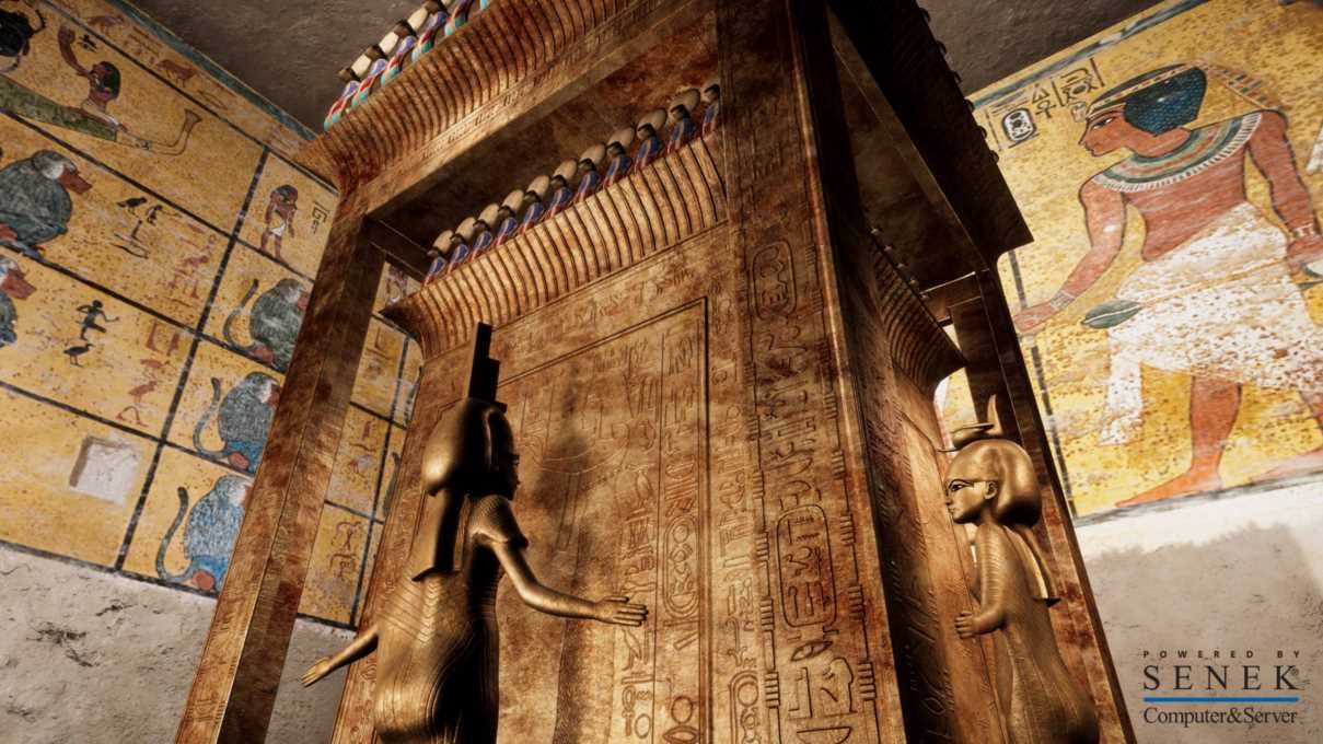 Ancient Egyptian tomb interior with detailed engravings and statues of deities in front of a large golden sarcophagus.