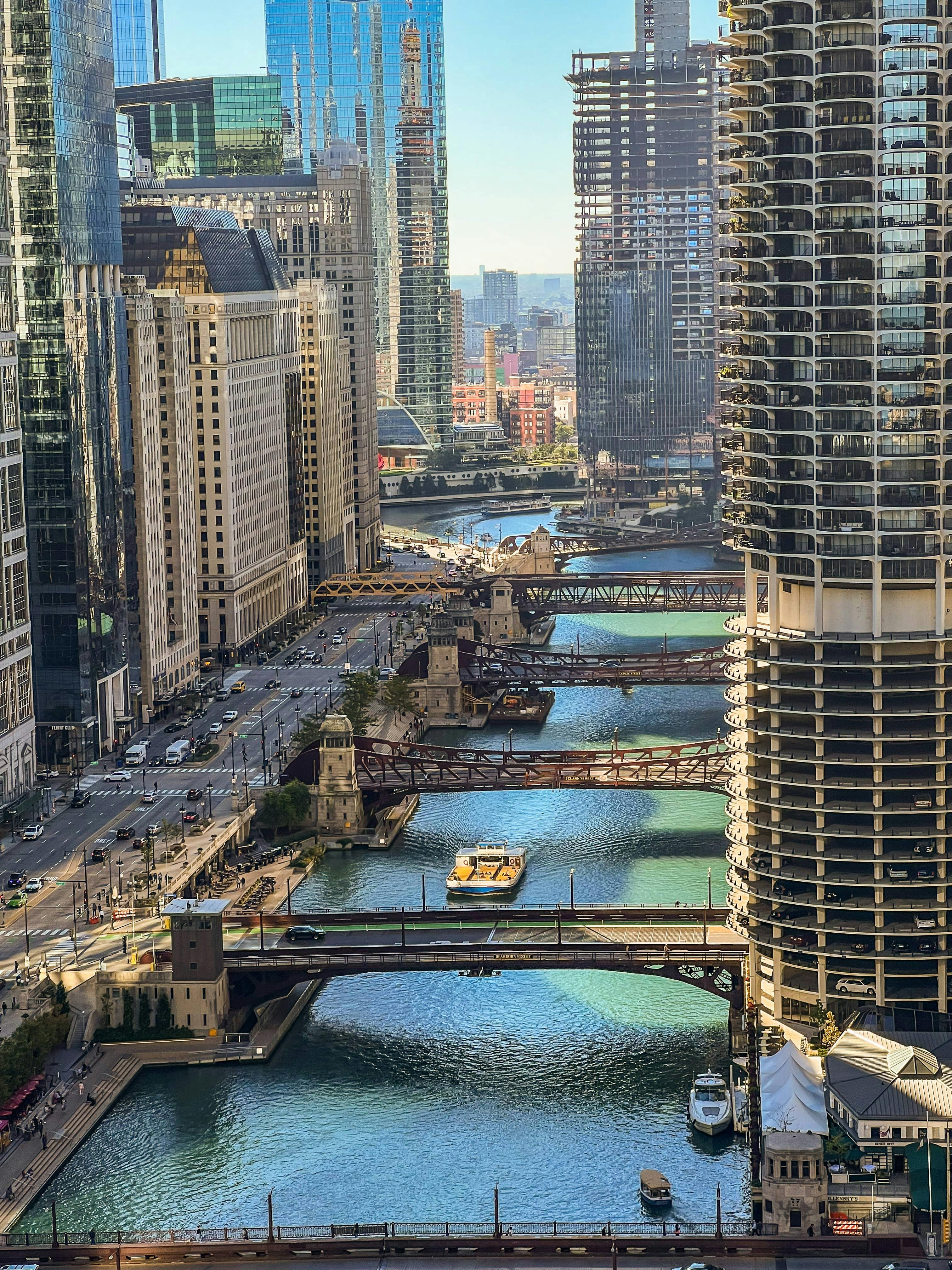 An aerial view of a cityscape with multiple bridges crossing a river, surrounded by tall buildings and bustling streets.