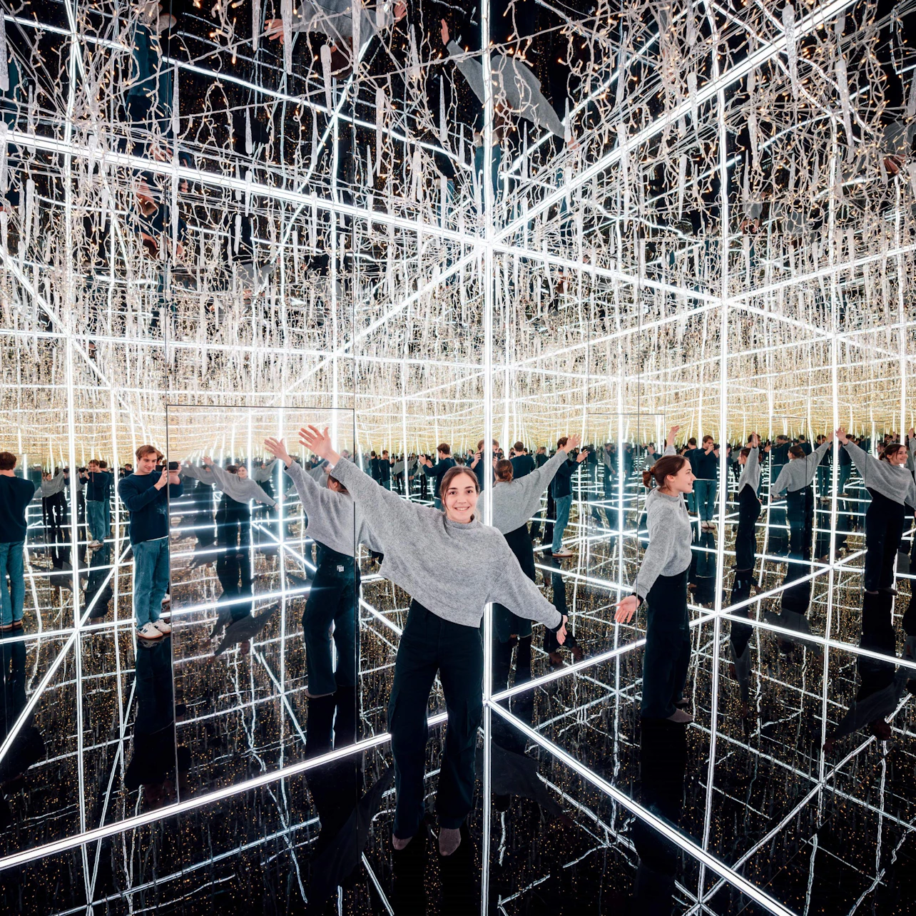 A visitor in the Ice Crystal Infinity Mirror Room – an enchanting space of endless reflections and glowing lights at Magic Ba