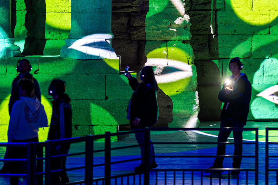 Odyssée Sonore spectators strolling across the Theatre stage