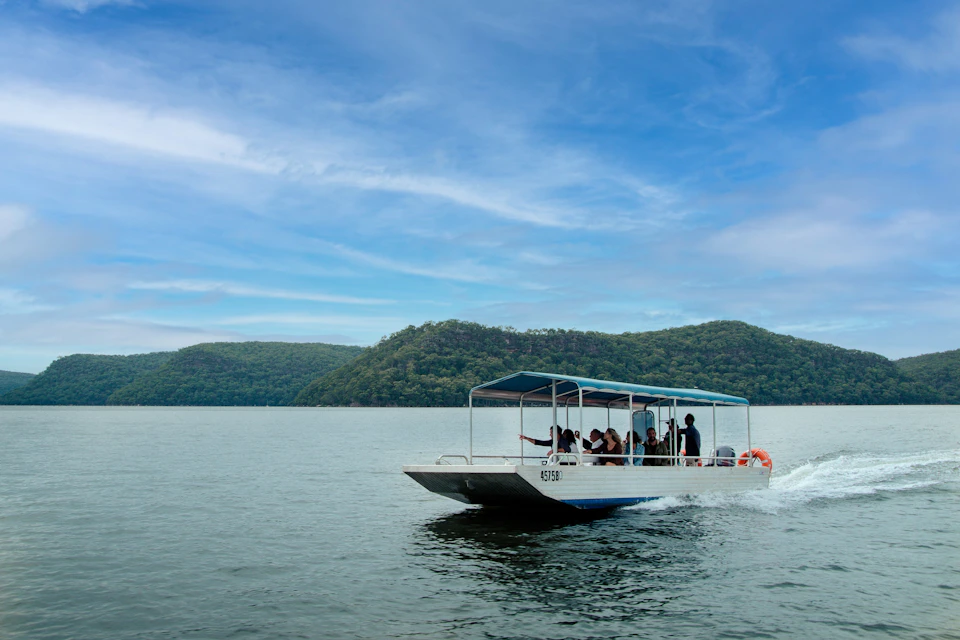 A tour boat is sailing on the Hawkesbury River.