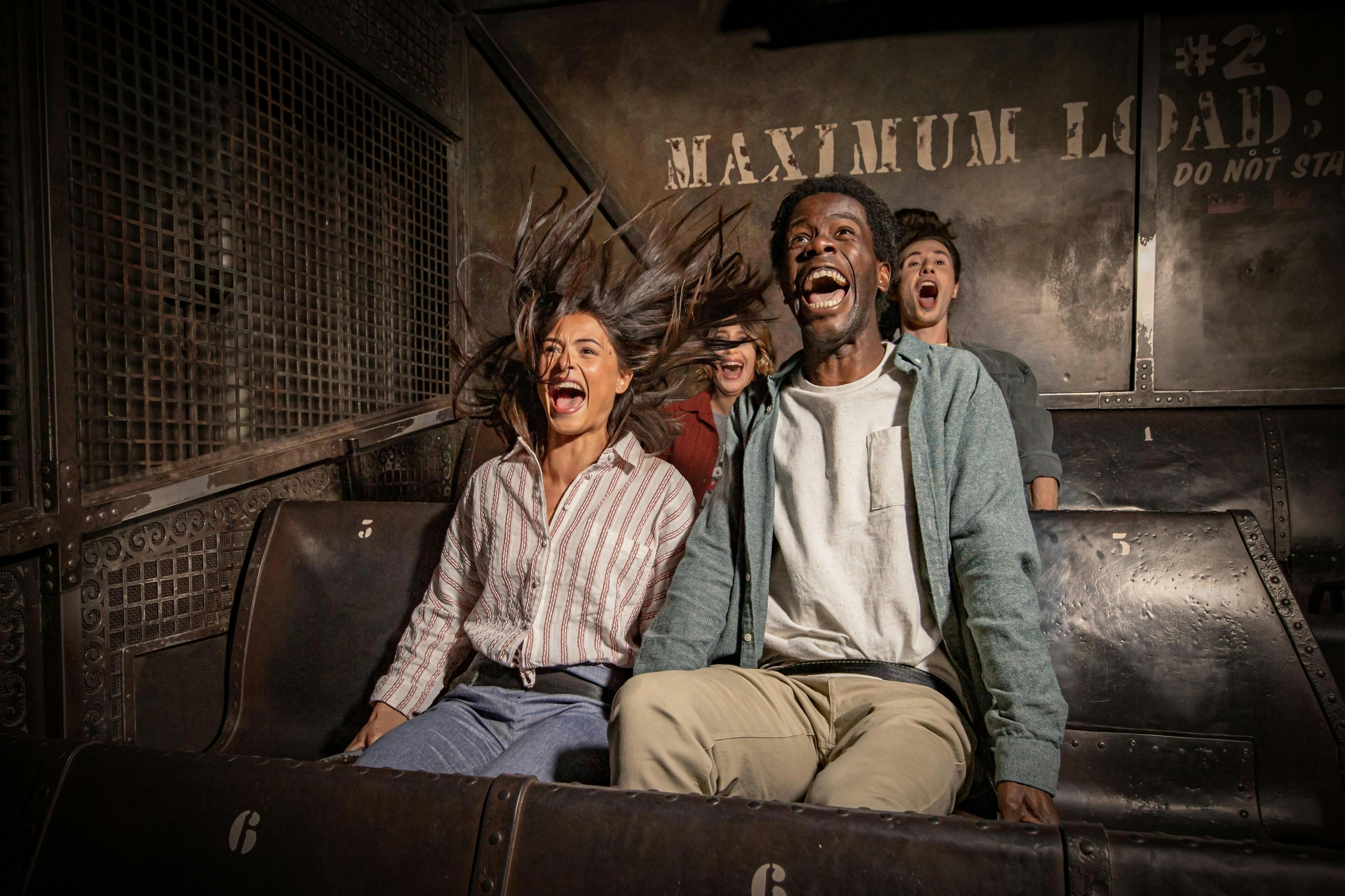 Two young coupkes are in the Tower of Terror, shouting into the attraction with a smile.