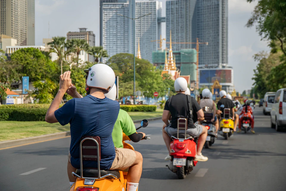 Discover the city of Phnom Penh on the back of a Vespa.