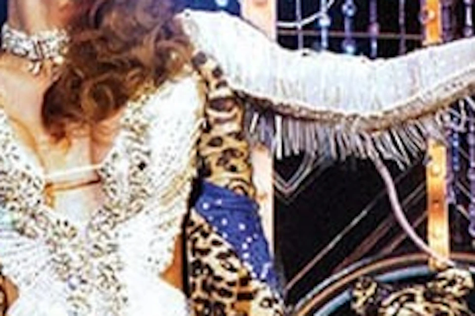 A dazzling performer from Tiffany's Show in Pattaya captivates the audience with her intricate costume and dynamic stage pres