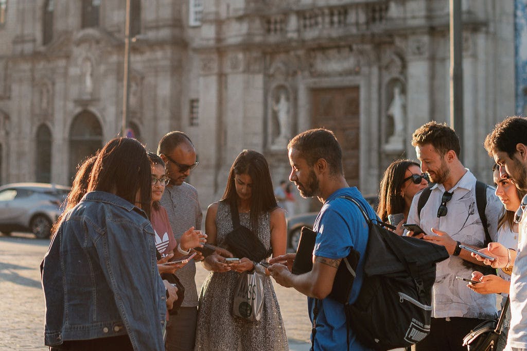 The group is interacting on their phones together.