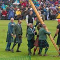 Highland Games - A caber being handed to a contestant to be tossed.