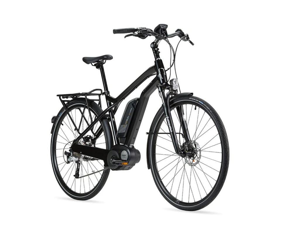 A black electric bicycle with a front suspension, disc brakes, and a rear cargo rack.