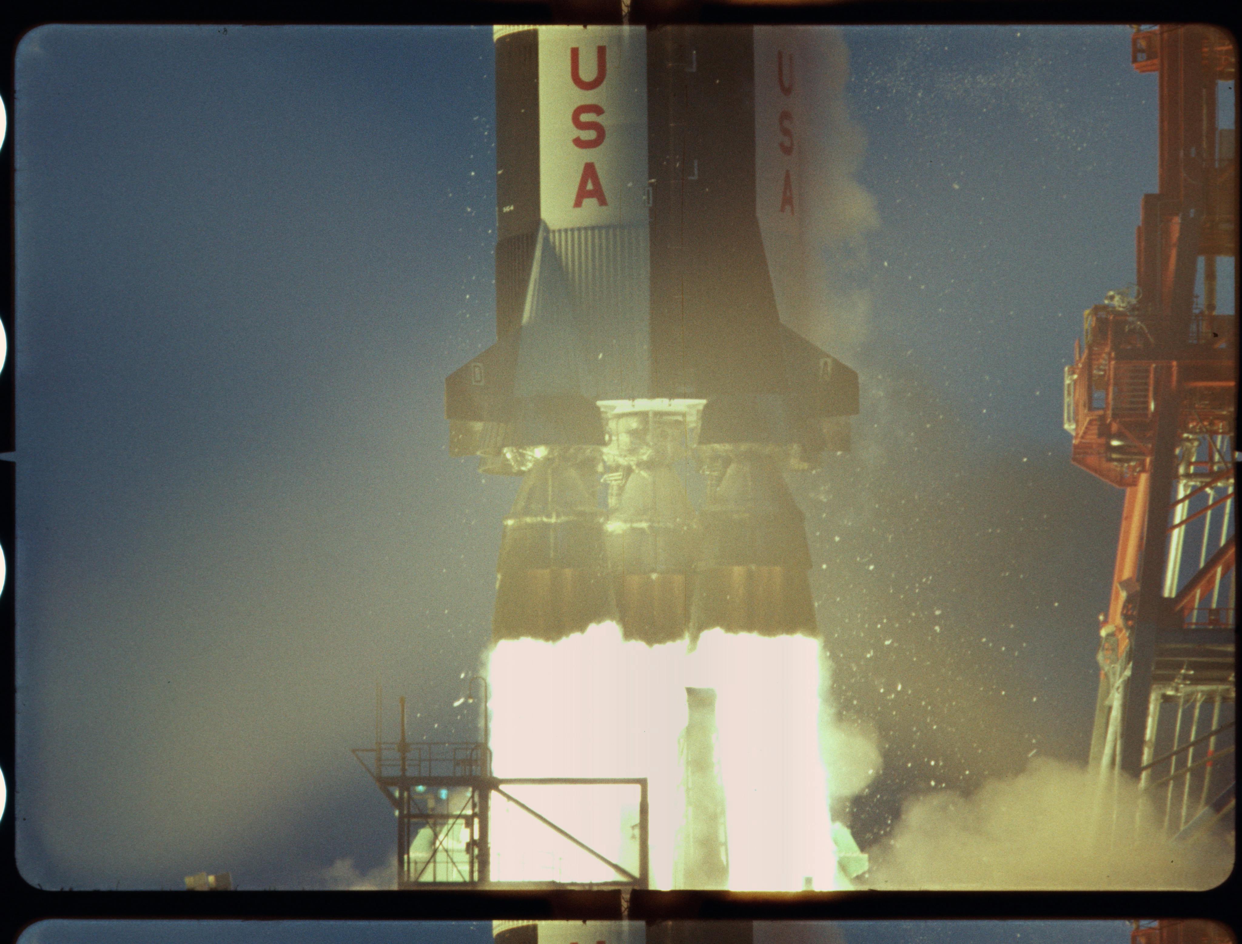 A rocket labeled "USA" launches with bright flames and smoke billowing from its engines.