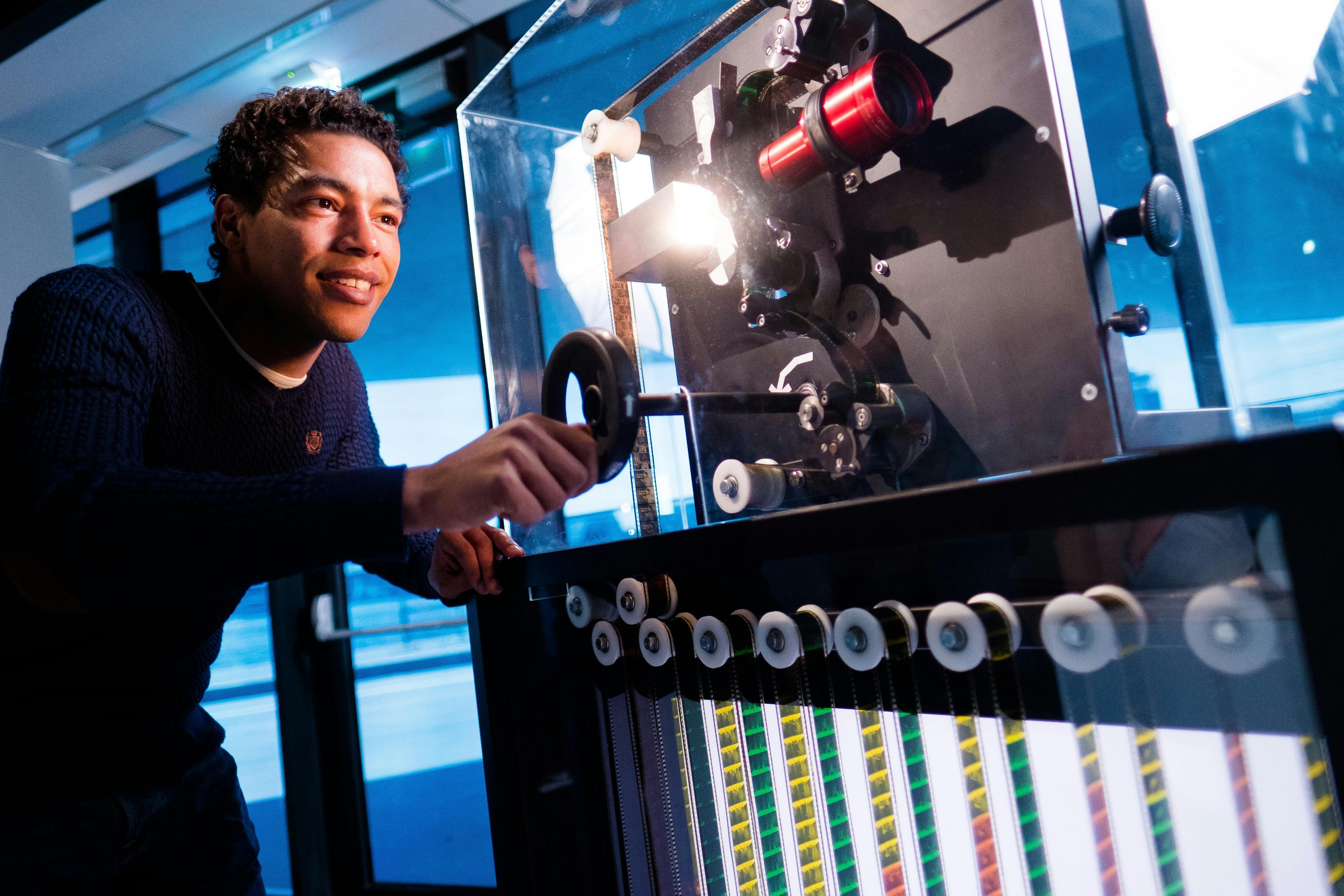 man looks through projector